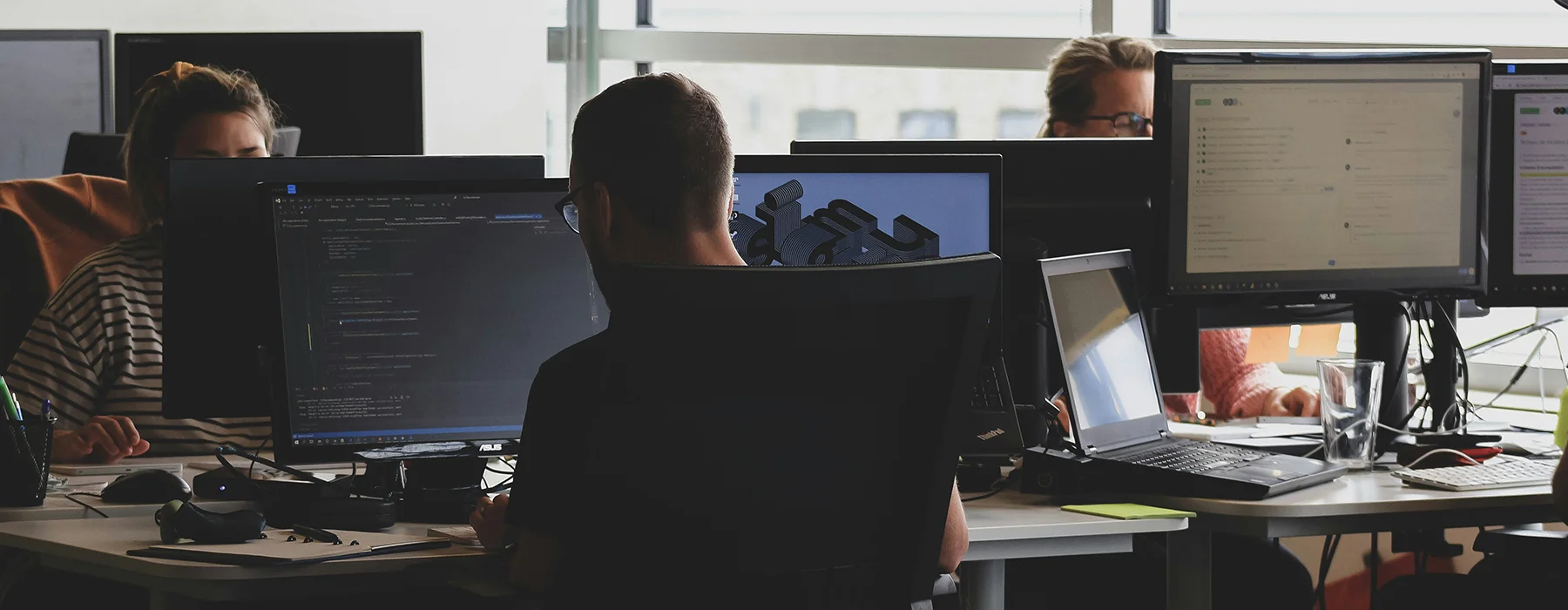 Software professionals collaborating in a modern technology workplace